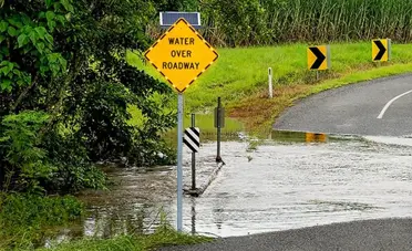 warning sign on flooded road